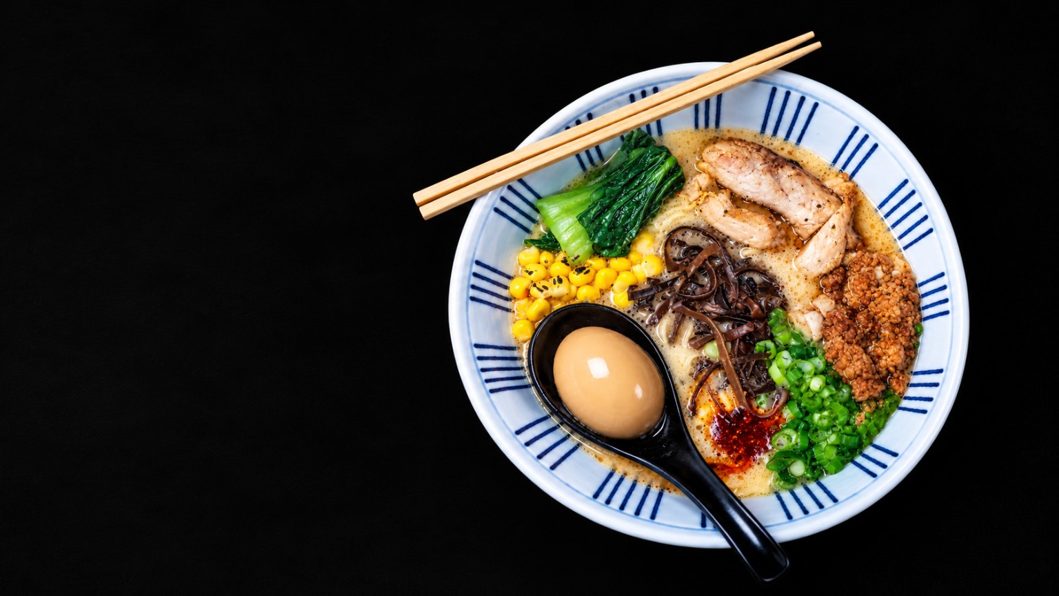 Rich ramen bowl with chicken, egg, vegetables and noodles
